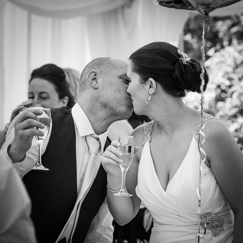 Passion - A secretly shared kiss between the happy couple on their wedding day. Sanctum on the Green, Maidenhead, England 2017